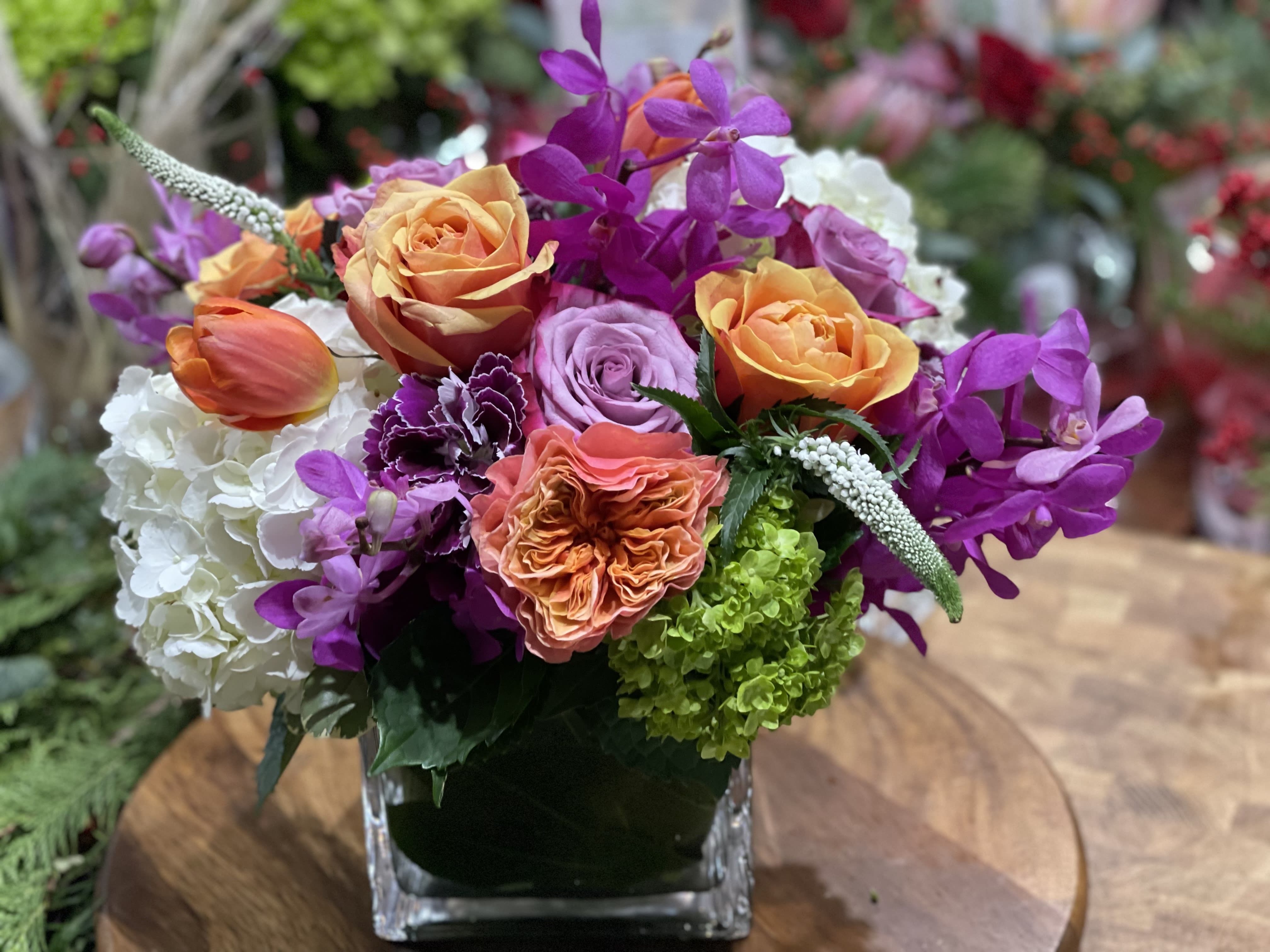 Raspberry Kiss - A bountiful medley of berry toned blooms.  Sure to brighten anyone’s day. 