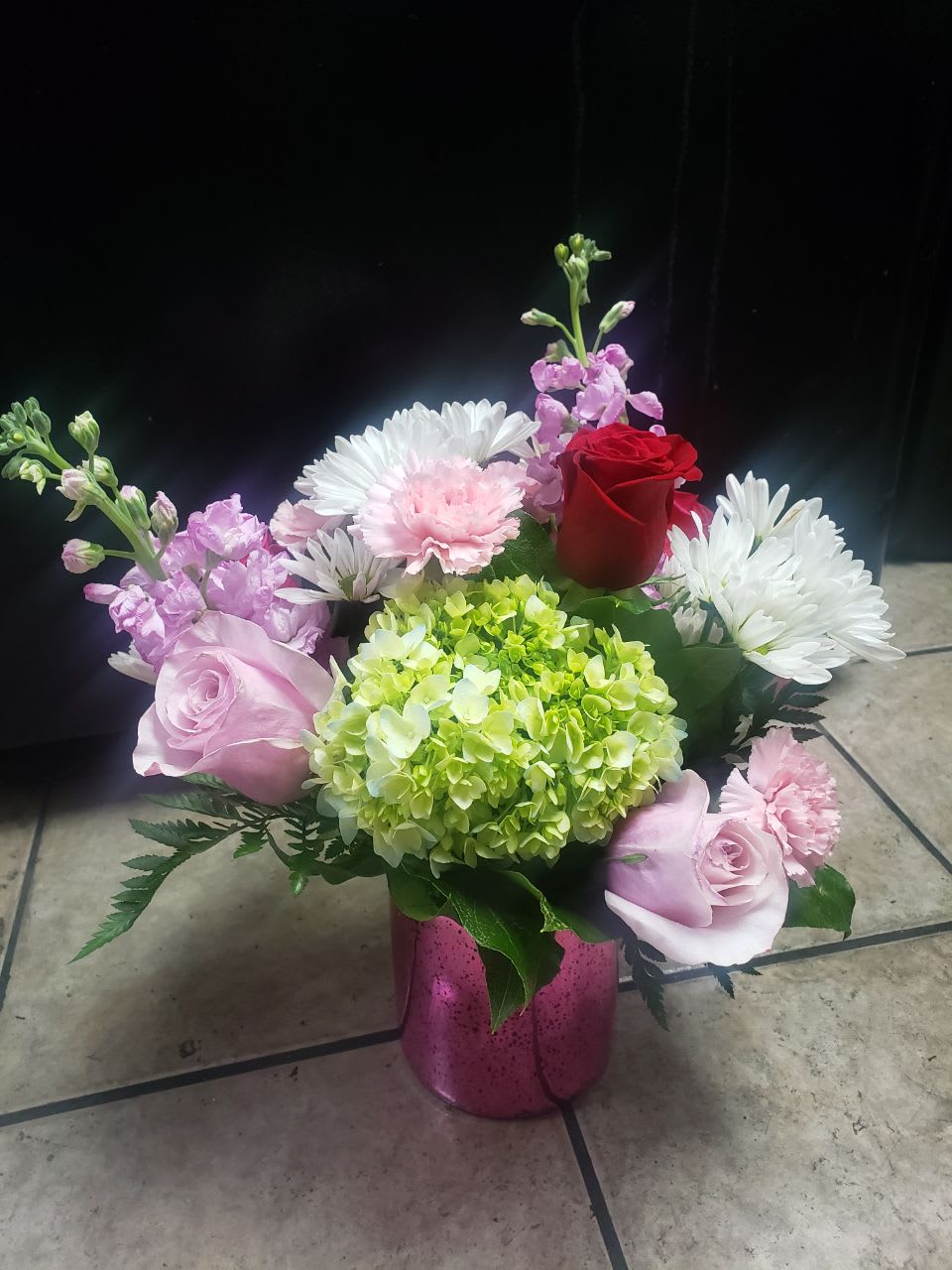 pink expression   - 1 green hydrangea,  3 stem  white daisy,  2  red roses,2 hot pink roses, 2 light pink roses, 5 pale pink carnation  and 2 pink stock  stems  everything of this amazing  flowers comes   in a pink vase.