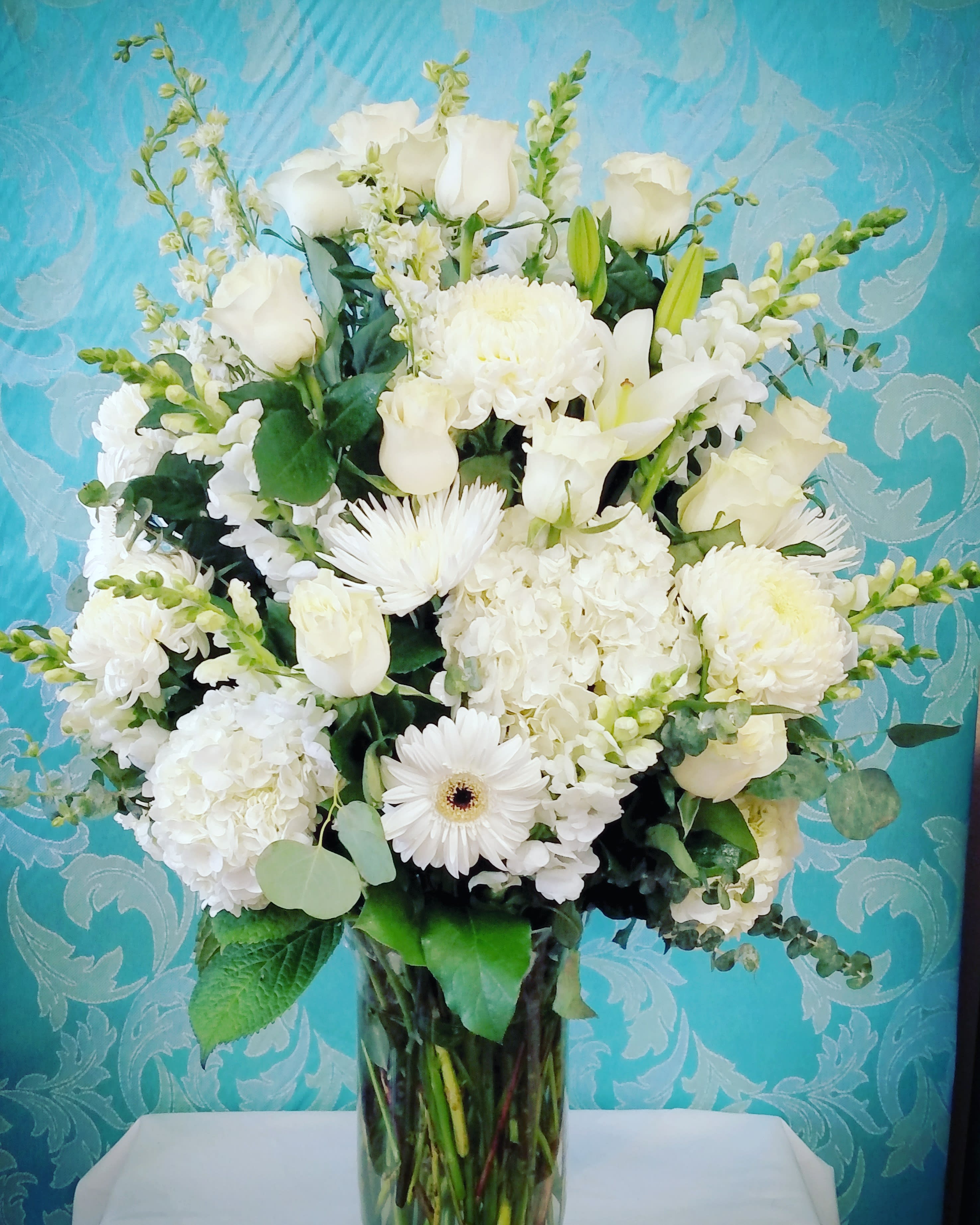 Heavenly White Blooms - This has to be our tallest and largest vase Bouquet available in all white roses, hydrangea, snap dragon and much much more. 