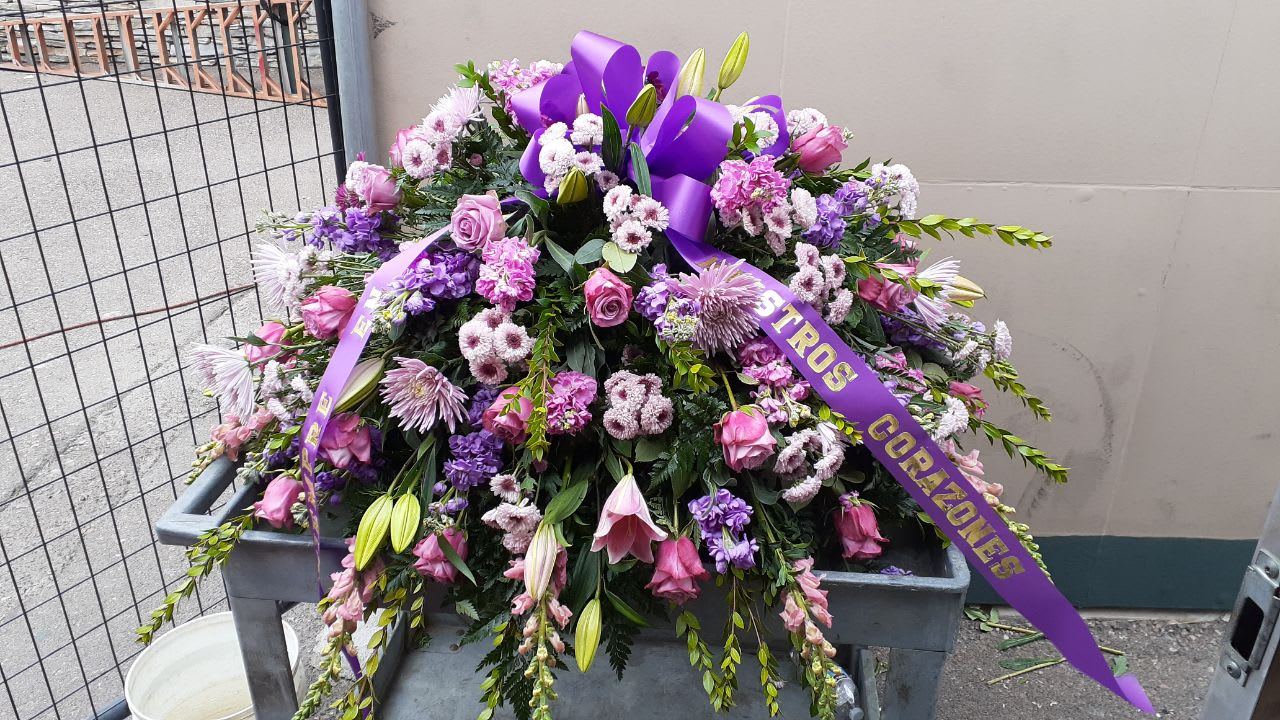 Purple Tribute - combination of different purples 24 purple roses,10 pink snap dragon, 10 lavender button stems, 6 purple stock,6 fuchsia stock, 6 lavender spider mums, 4 pink stems of lilies with a mix of leather leaves, salad tip and myrtle and also comes with a purple bow.