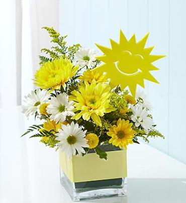 It's Your Sunny Day It's Your Sunny Day - Surprise them with a day of sunshine and smiles. Our luminous bouquet of daisy poms, carnations and more is brightly displayed in a glass cube vase. (Vase/Basket style may vary) Item # 90922