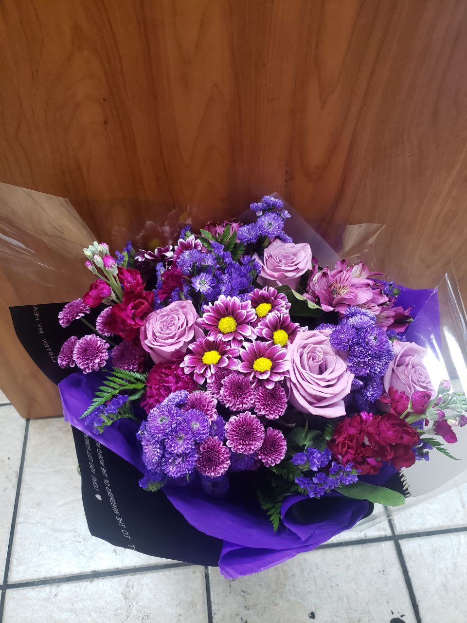 Expressions In Purple - A nice a pretty bouquet   with different shape of purple   like    purple daisies, carnations, some roses, purple stock, purple astromelias,  purple Stacie with some green leaves, these beautiful flowers wrapped with black and purple paper with beautiful purple bow.