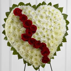 Broken Heart Standing Spray  - The Broken Heart is a beautiful way to express the impact that the departed had on your life. Pearly white chrysanthemums form the shape of a heart, accented with greens lined around the outside and &quot;broken&quot; in the middle with a line of rich red roses to create an exquisite way to honor the life of the deceased