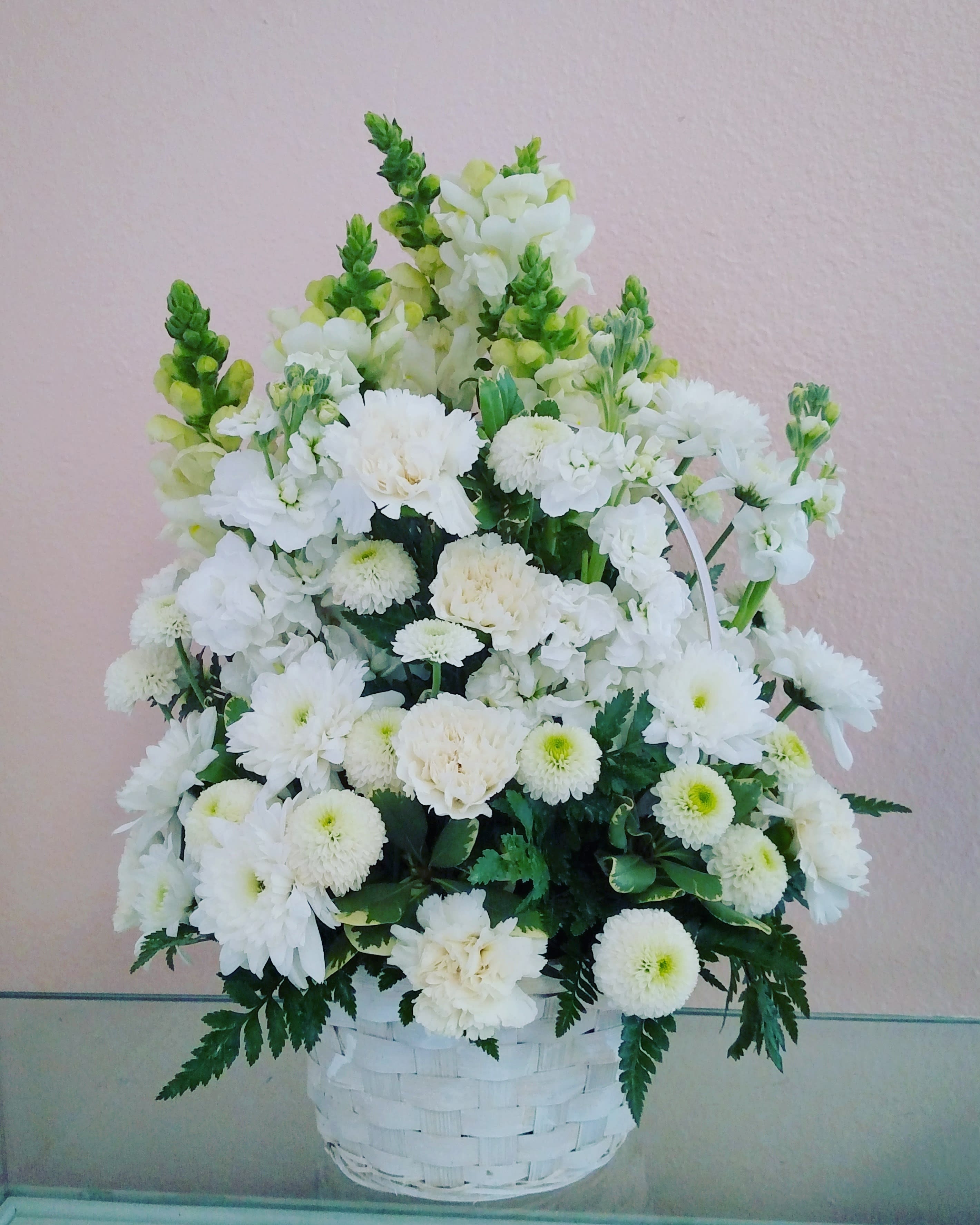 Basket Of white Blooms - White wicker basket with white bloomed flowers such as snap dragon, carnations and chrysanthemum. You can also choose any other color added.