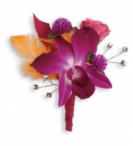 Dance 'til Dawn Boutonniere Dance 'til Dawn Boutonniere - An electric arrangement of purple orchids, hot pink roses and orange feathers. Purple dendrobium orchids, hot pink spray roses and purple gomphrena accented with orange feathers. Approximately 3 1/2" W x 4" H Orientation: N/A