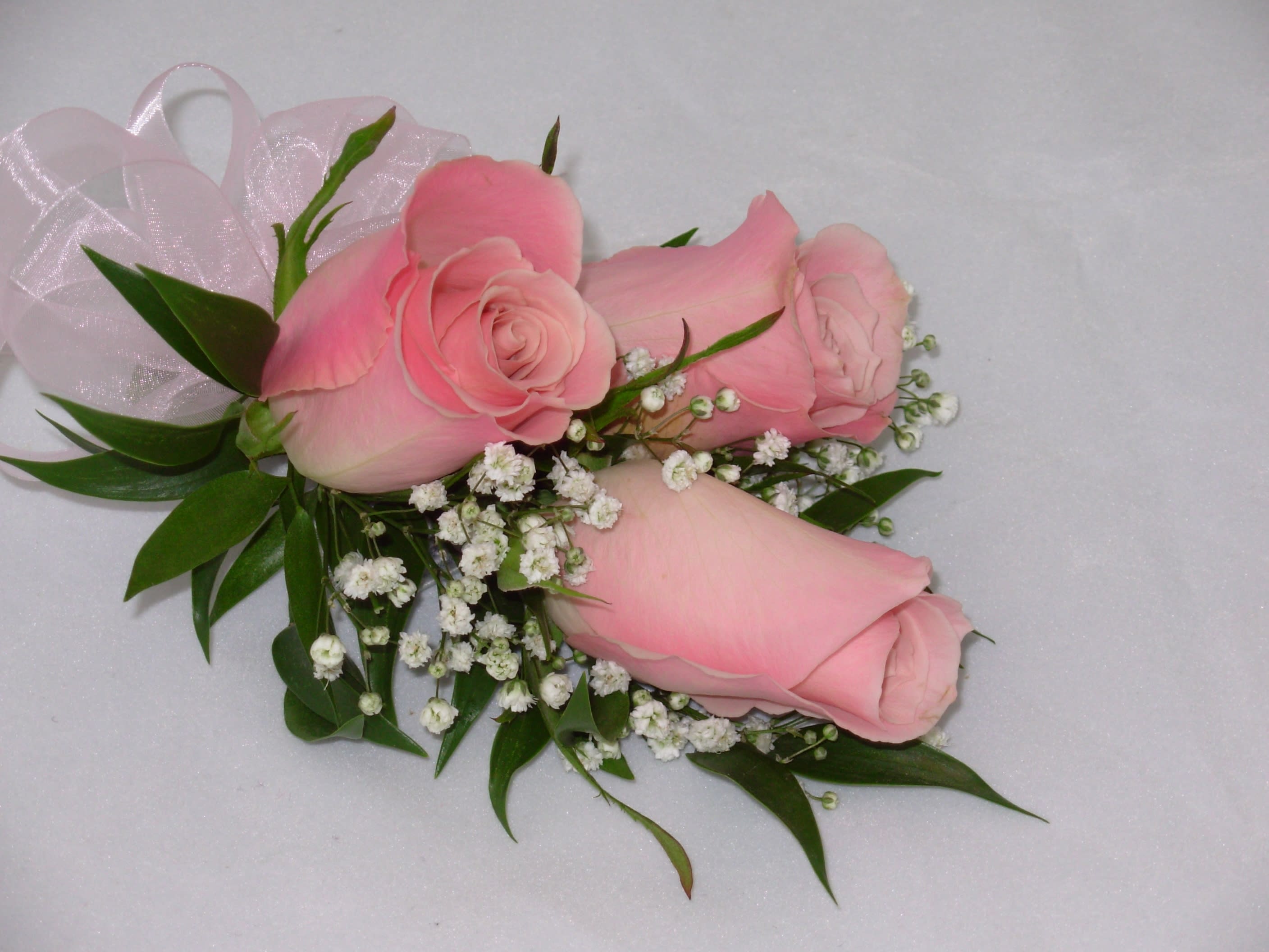 Kerri's Corsage - This beautiful corsage features three light pink roses along with a light touch of baby's breath, perfect for your next event!
