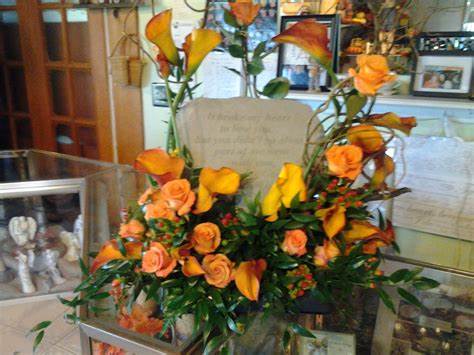 Custom Specialty Stone Design - Let our creative designers encase your specialty stone with calla lillies, roses and other flowers to make just the right style for your loved one.  Specialty Stones and Floral Colors can be chosen while consulting with designer.