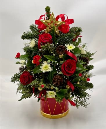 Christmas Traditions Holiday Tree - Set up this Christmas traditional tree as a centerpiece or give as a gift full of holiday spirit. Tree filled with mixed Christmas greens, roses, mini carns, mums, and pine cones. This tree comes in one size only 