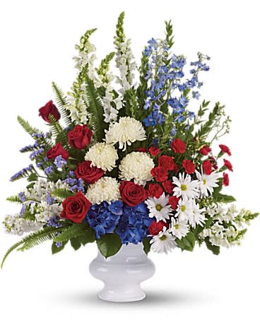  With Distinction [T240-1A] - A dazzling display of patriotic red, white and blue flowers sends a silent yet poignant statement about hope, freedom and the strength to endure. This proud bouquet is a testament to life that is sure to be appreciated.  A beautiful mix of all-American red, white and blue flowers such as hydrangea, roses, miniature carnations, snapdragons, chrysanthemums and more are perfectly arranged in a white urn.  Approximately 30 1/2&quot; W x 34 1/2&quot; H  Orientation: One-Sided      As Shown : T240-1A 