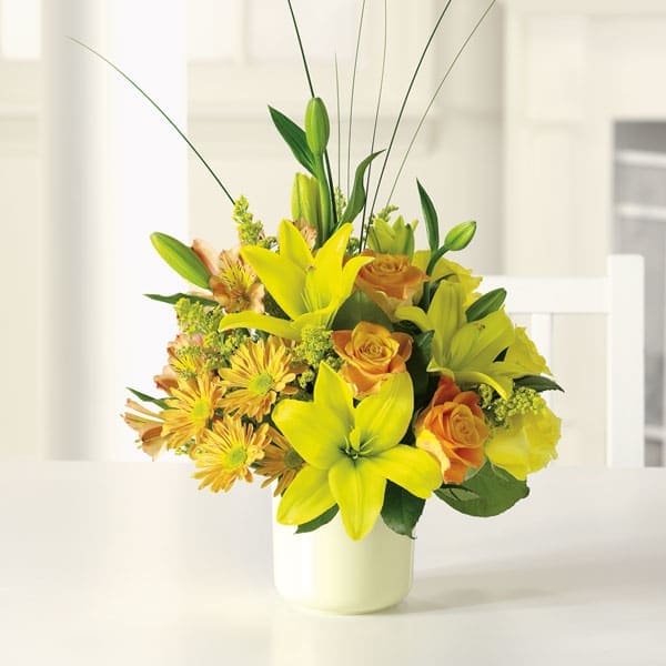 Sunshine Splendor - Bright-yellow lilies and fire-orange roses awaken the senses with sunny greetings for any occasion. Brighten someone's day today!