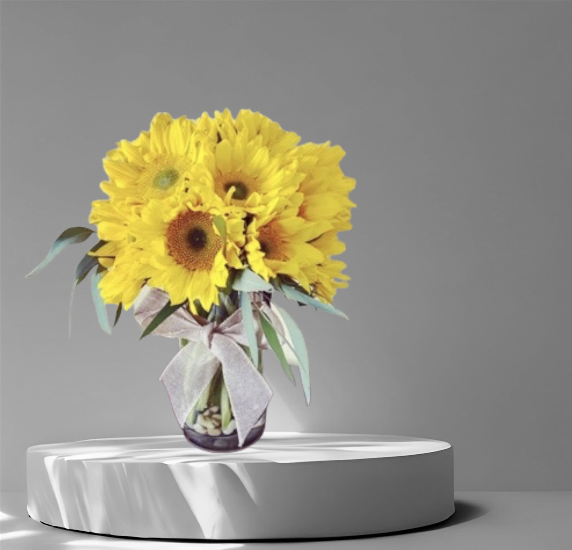 Sunny - An all around bright and cheerful arrangement created with beautiful Sunflowers in a glass vase tied with a bow! 