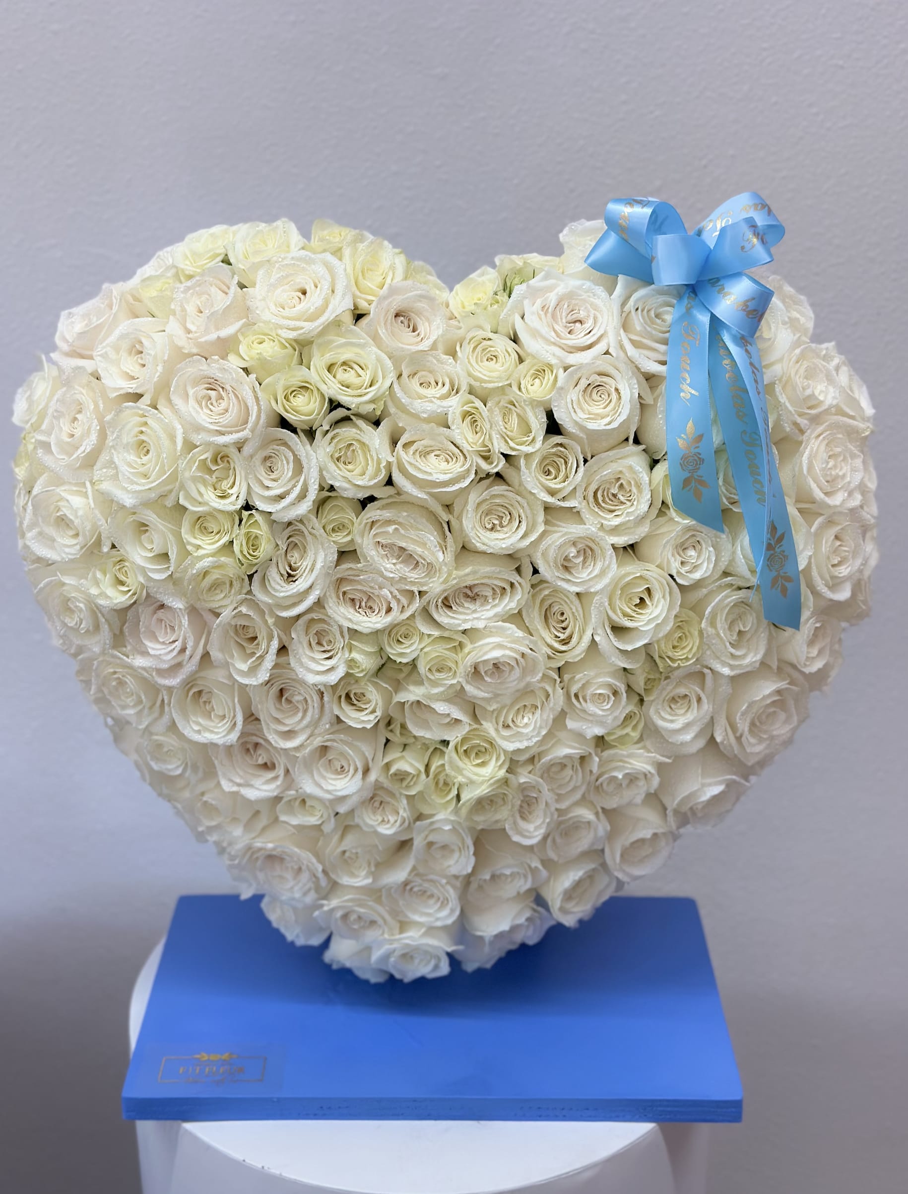 Heart u - Arrangement has a wooden base. Filled with Roses and spray roses filled all around shaping a heart. 