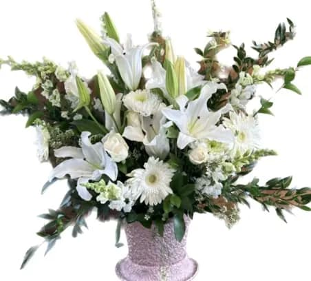 Bright Star Bright Star - A wispy white arrangement featuring casa blanca lilies, eucalyptus and myrtle. This arrangement smells lovely and is suitable for any type of ceremony. *If you feel inspired to add color please add to the details.