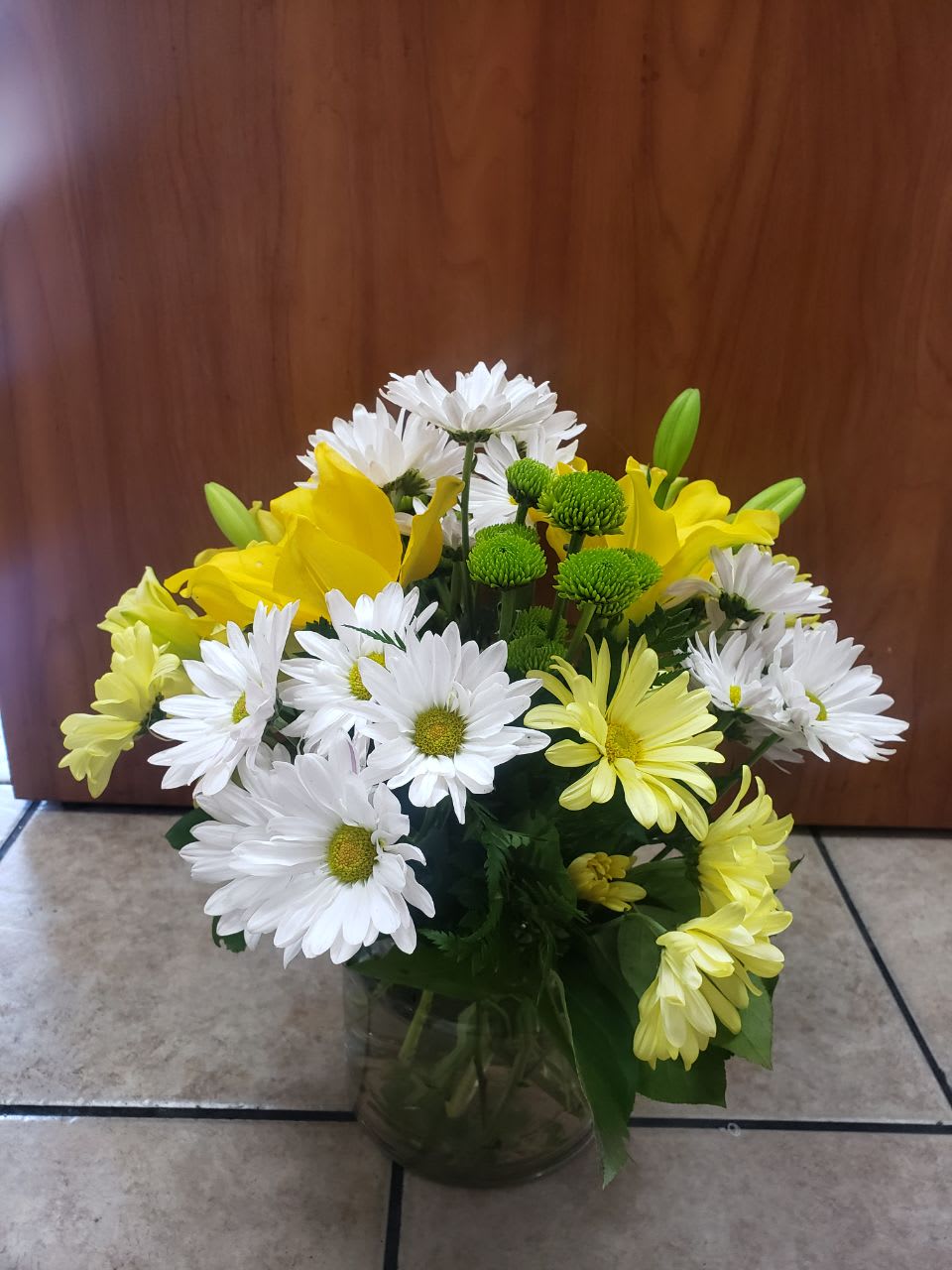 Bouquet Of Happiness - 3 stem of white daisy, 3 stems  yellow daisy, 2 yellow Asiatic lilies, 2 green button, this flowers  contain in a clear small  cylinder  vase.