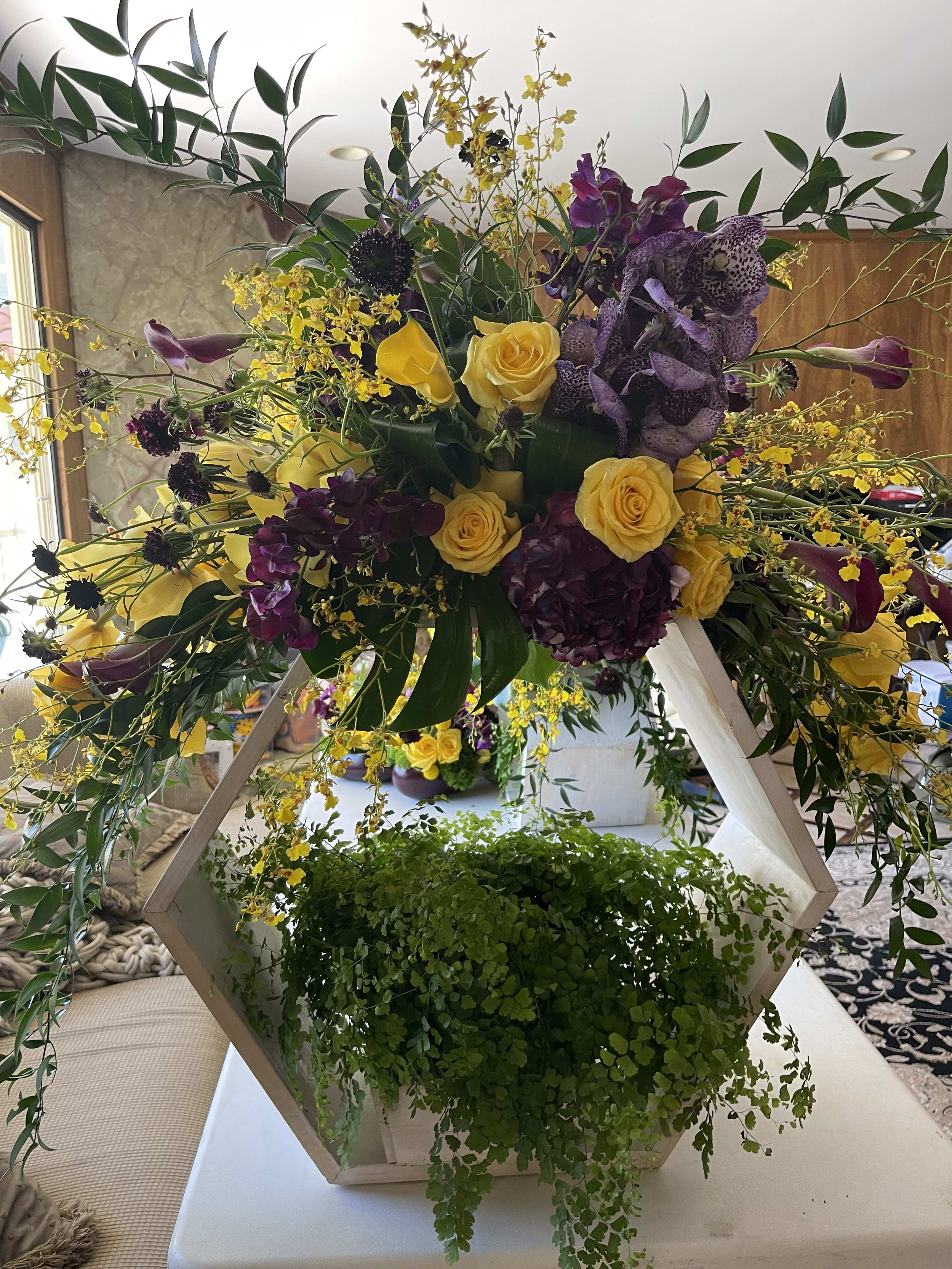 Purple and Gold Bliss - A beautiful and grand arrangement with gold and purple roses, cymbidium orchids, tulips, oncidium orchids, wanda orchids, billy balls and scabious!   This arrangement comes in two different sizes, Large and Grand (XL).  Please choose the $500 version for Large and the $750 version for Grand (XL).