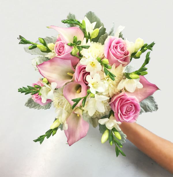 PinkCallas-RoseBouquet - Elegant bridal bouquet with roses, pink callas, freesias, dahlias hand tied with greens and ribbon stem wrap.