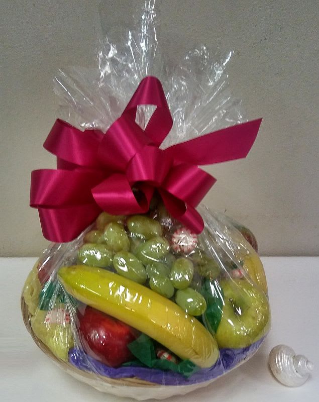 Fruit Basket Sampler Fruit Basket Sampler - This fruit basket contains items such as red apples, golden apples, pears, plums, oranges, bananas, grapes with a sprinkling of candies. Selection may vary slightly depending on the season.