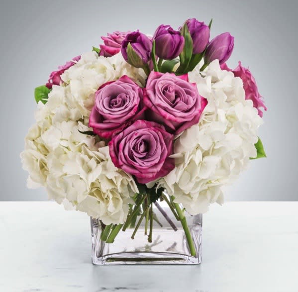 Lovely Lilac -  Sending this clean purple and white arrangement featuring lavender roses and white hydrangea is a way to show you care and are thinking of them.  Approximate Dimensions: 11&quot;D x 11&quot;H