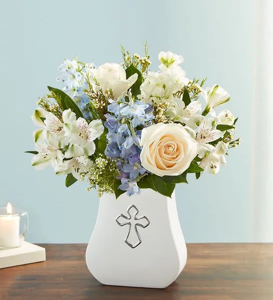 Sacred Blessings™ Blue &amp; White - One thoughtful gesture can bring peace and comfort when it’s needed most. Our elegant arrangement of soft blues and whites is hand-arranged in our white, ceramic Sacred Blessings Vase, featuring a silver embossed cross. It’s a beautiful reminder that hope and love live on in our memories.
