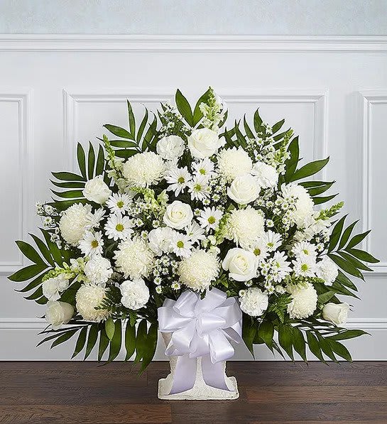 Heartfelt Tribute™ White Floor Basket Arrangement - There’s a feeling of peace and tranquility that white flowers can bring to those who are grieving. Our elegant all-white floor basket, handcrafted by our caring florists with lush white blooms, is a tasteful gesture perfectly suited for the funeral home or memorial services. All-white floor basket arrangement of roses, football mums, snapdragons, carnations, daisy poms and monte casino; accented with soft, lush greenery