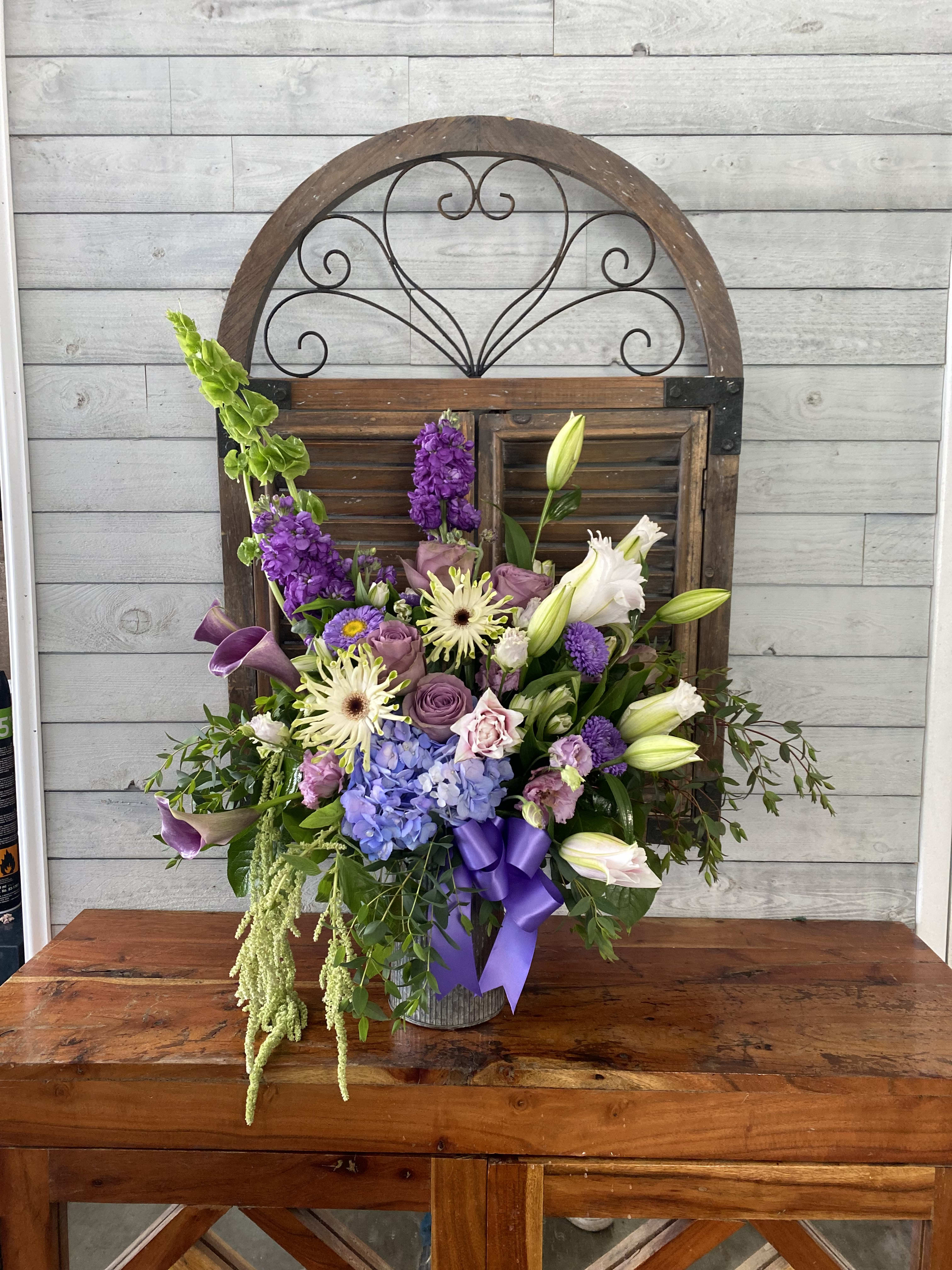 About happiness  - Lavender and purple flowers in a rustic container.