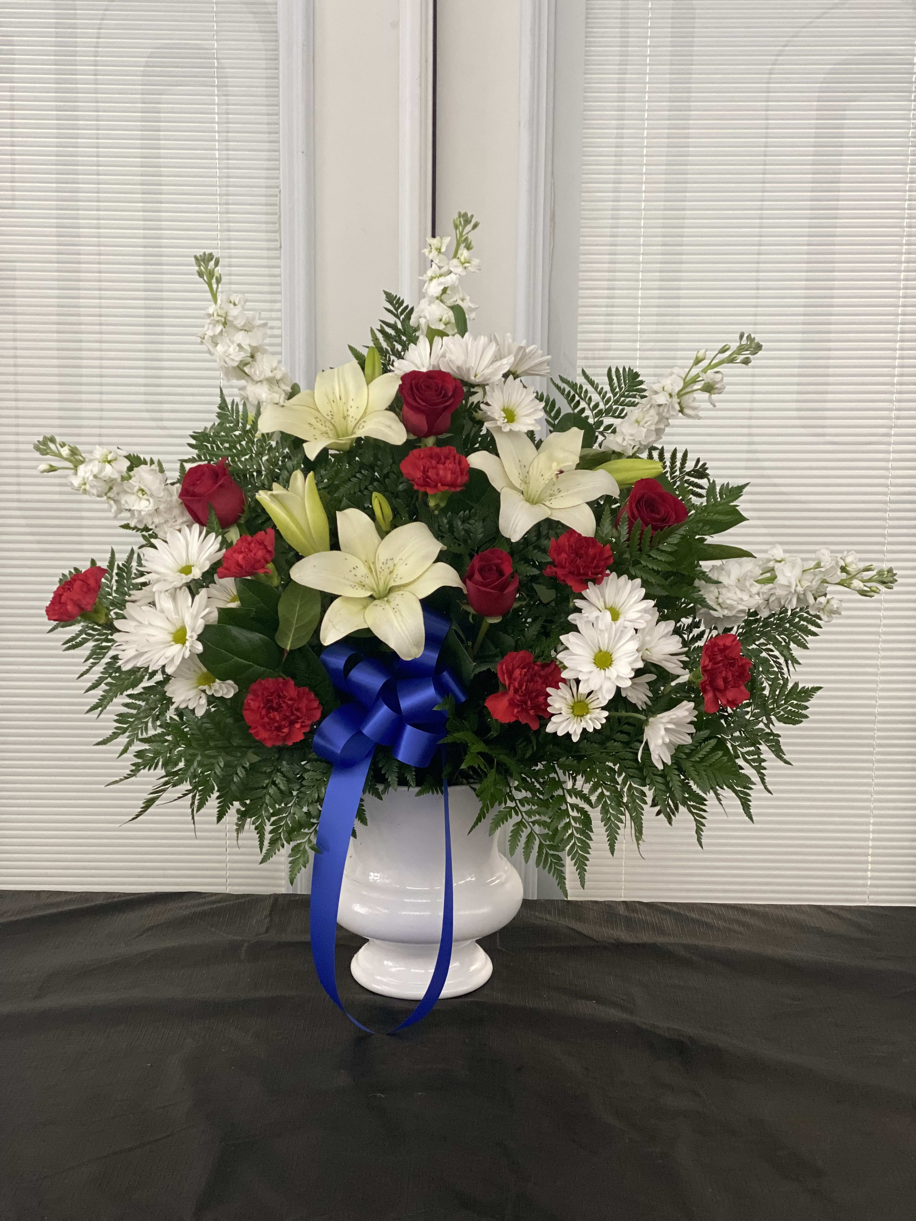 Red White And Blue Sympathy Standing Basket - Convey your deepest condolences for a beloved veteran with this touching tribute. Our florists arrange beautiful red, white and blue flowers such as roses, hybrid lilies, cremones, delphiniums, carnations and more Traditionally sent by family, friends or business associates Sent directly to the funeral home 