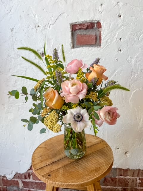 Premium Posy - This Posy is perfect for the girl who knows her flowers. This design features ranunculus and anemone. It also comes in a fluted mason jar that we think is super cool!