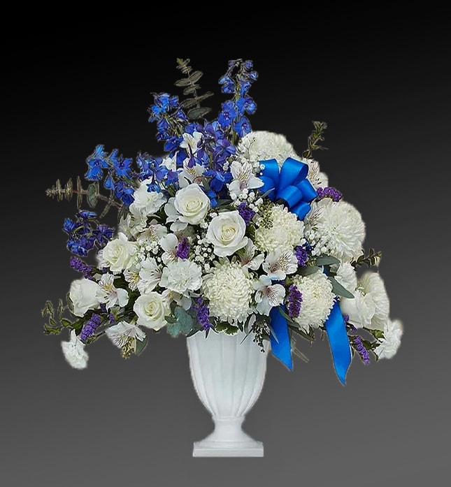 Life Remembered - The greatest tribute is to remember a lost loved one as they lived. To comfort friends and loved ones of the departed, our florists hand-arrange fresh roses, carnations, delphinium and more in shades of blue and white in a graceful keepsake pedestal vase. Elegantly crafted with satin finish and delicate fluting, a timeless vase that can be used to hold flowers or on its own as an objet d’art.