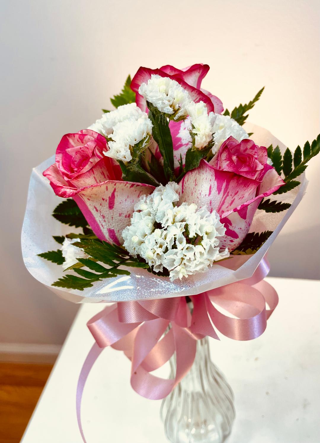 Young daughter's mini bouquet - Created for young girls attending a promotion or retirement ceremony. Very popular for the girl and family! Roses, fern,a collar and ribbon streamers resemble a tiny bridal bouquet.