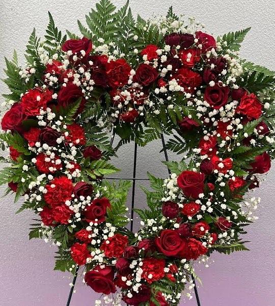 Standing Heart Spray of Red Roses Standing Heart Spray of Red Roses - This heart shaped wreath of red roses & carnations features a classic and elegant look.