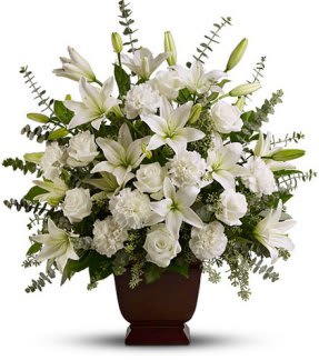 Sincere Peace - Sincere Peace is is a beautiful tribute to a life well lived. White carnations pair with white lilies and white roses. Accented with baby blue and seeded Eucalyptus with other mixed greenery in a keepsake urn. ( Urn may vary from one shown.)