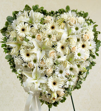 White Heart - Product ID: 91282   This solid heart standing spray makes a beautiful statement about your heartfelt compassion and sympathy. White flowers such as roses, lilies, Gerbera daisies, carnations and more Solid heart with oasis, tied to the wire easel with satin ribbon Sent directly to the funeral home by family, friends and business associates Our florists use only the freshest flowers available so components may vary Measures approximately 24&quot;H x 24&quot;L