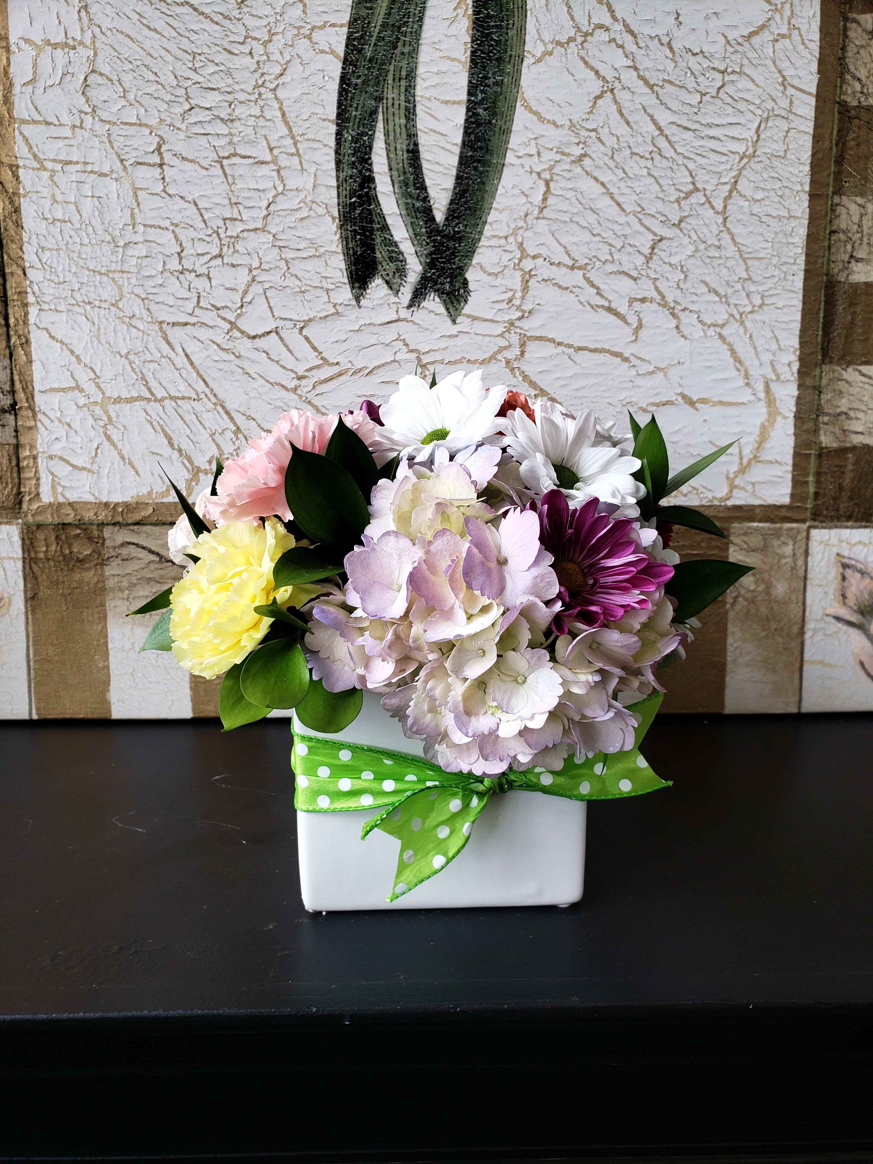 Seasonal Cube Arrangement (Assorted Seasonal Flowers) - Assorted Seasonal Flowers tastefully arranged in a white ceramic cube. Sealed with a fun bow for that added pop of color. For upgrade options or special requests, please contact our shop directly at 732-341-3723.   * Seasonal flowers may vary based on availability. 