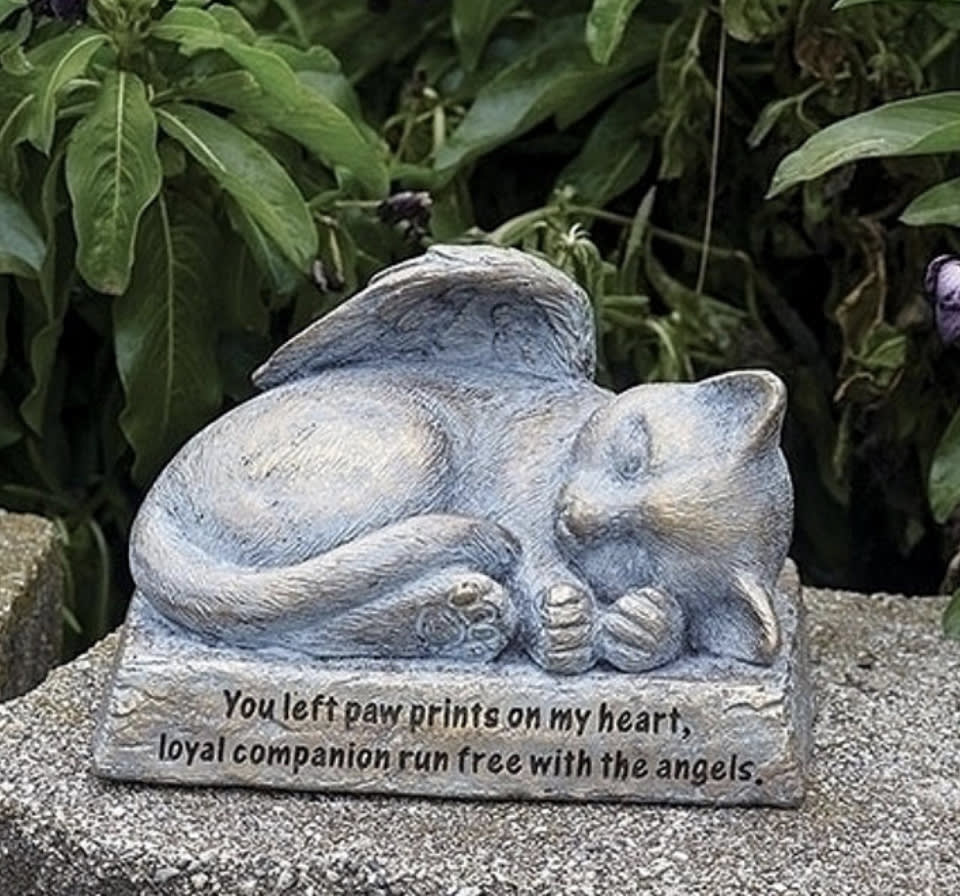 You Left Paw Prints on my Heart Cat Angel Garden Statue 6 Inch Long - Gentle and kind, this garden memorial statue of a cat with wings helps remind us how special the companion was. On the base there is a message: You left paw prints on my heart, loyal companion run free with the angels. Made from a resin stone mix this small statue measures 5.5&quot; H x 4.2 W. 
