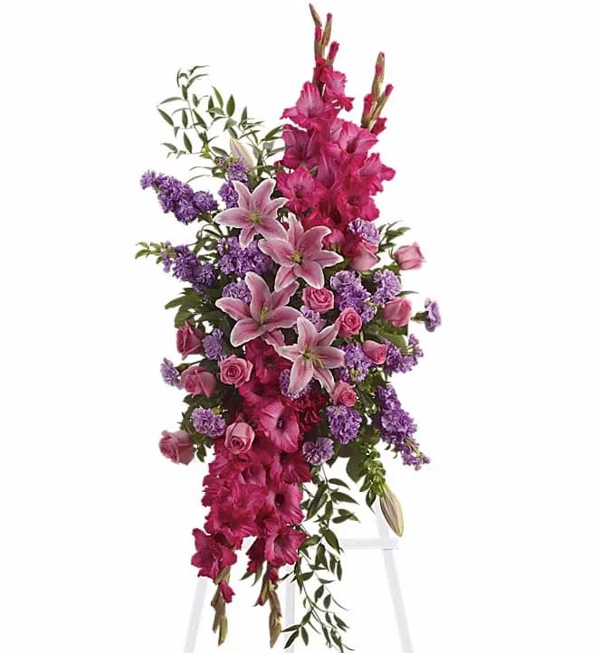Touching Tribute Spray - Express admiration for her beauty and spirit with a striking tribute certain to evoke many cherished remembrances. Gorgeous flowers such as pink roses oriental lilies and gladioli blend with purple stock lavender carnations and fragrant greens.