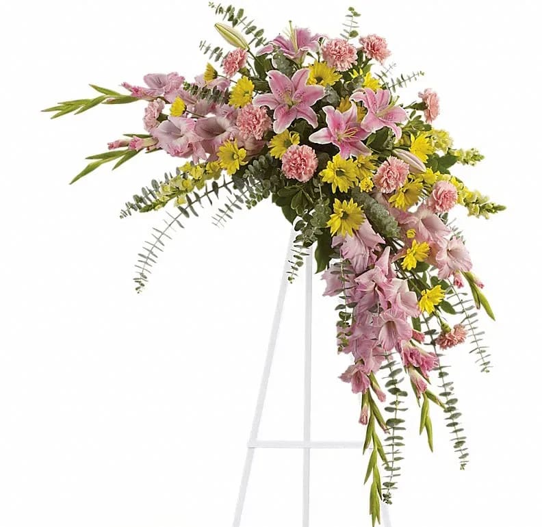 Sweet Solace Spray - Rejoice with this softly dramatic cascade of pink and yellow blooms - lilies gladioli and chrysanthemums - that has hints of eucalyptus and variegated greens. Stems of flowers such as pink lilies gladioli and carnations with yellow snapdragons and daisy spray mums accented by variegated greens and eucalyptus.