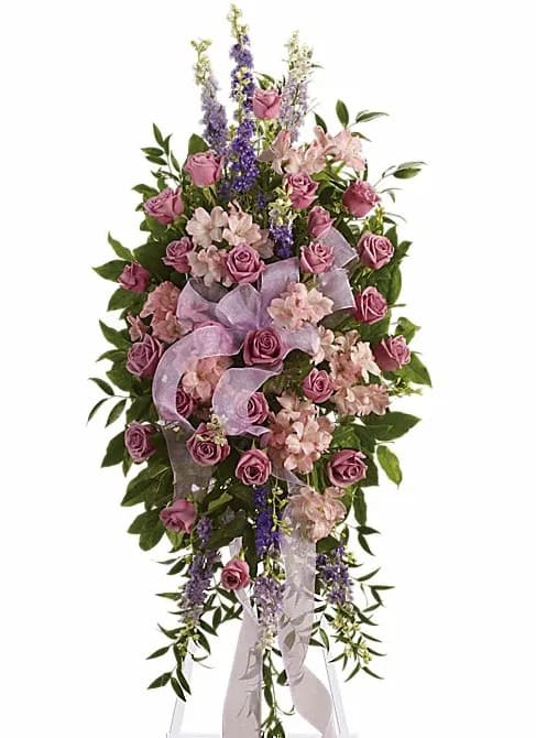 Finest Farewell Spray - Utterly feminine this spray is an extraordinarily beautiful way to bid farewell to someone who will remain forever in your heart. A bevy of lovely lavender flowers will soothe souls and deliver strength and hope to those in mourning. Beautiful flowers such as lavender purple and pink blossoms including roses larkspur alstroemeria and more are beautifully arranged. A pretty pink organza ribbon completes this fine farewell.