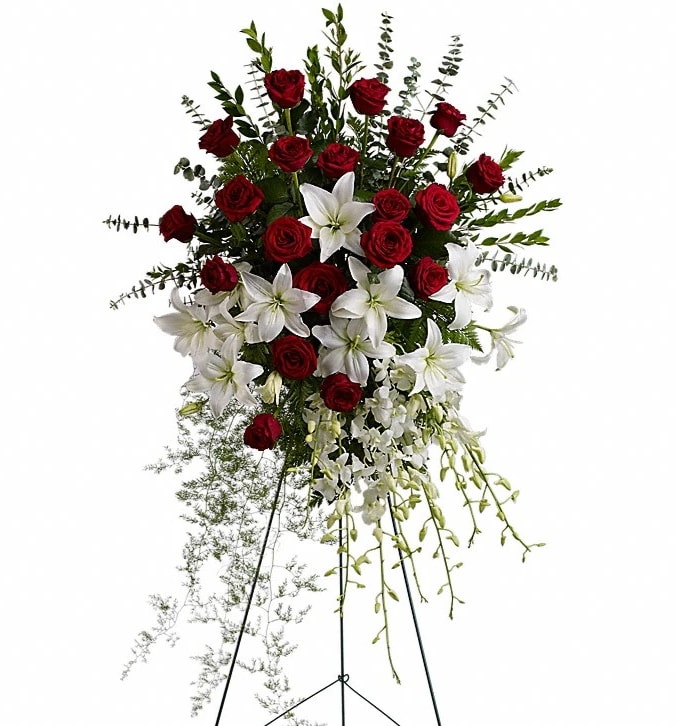 Lily and Rose Tribute Spray - Pure white lilies and dendrobium orchids mingle with red roses white asiatic lilies and more in this magnificent and impressive standing spray of the finest blooms. A fitting tribute for a funeral wake or memorial service. A standing spray of lush flowers such as red roses white dendrobium orchids and asiatic lilies - accented with greenery - is delivered on an easel.