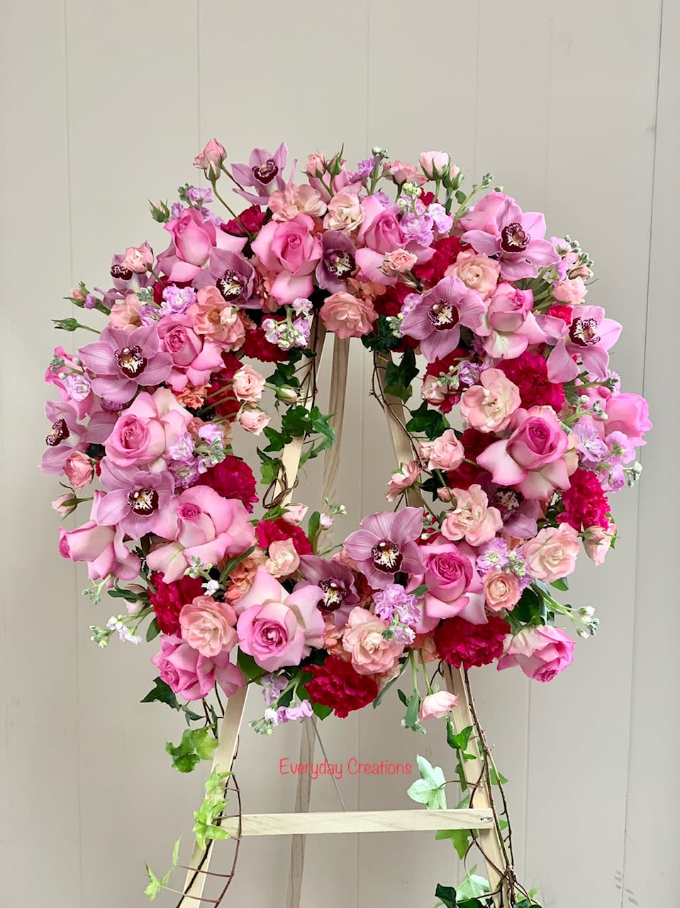 SYM04 - All Pink Funeral Wreath - The warmth and kindness they showed will live on forever, and sometimes this sentiment is best captured through flowers. Our impressive standing funeral wreath arrangement, meticulously handcrafted by expert designers with soothing pink blooms for a lush, full presentation, creates a truly memorable tribute. Crafted in a round design, this magnificent pink funeral wreath features the highest quality luxury blooms such as roses, stock, spray roses and cymbidium orchids. 