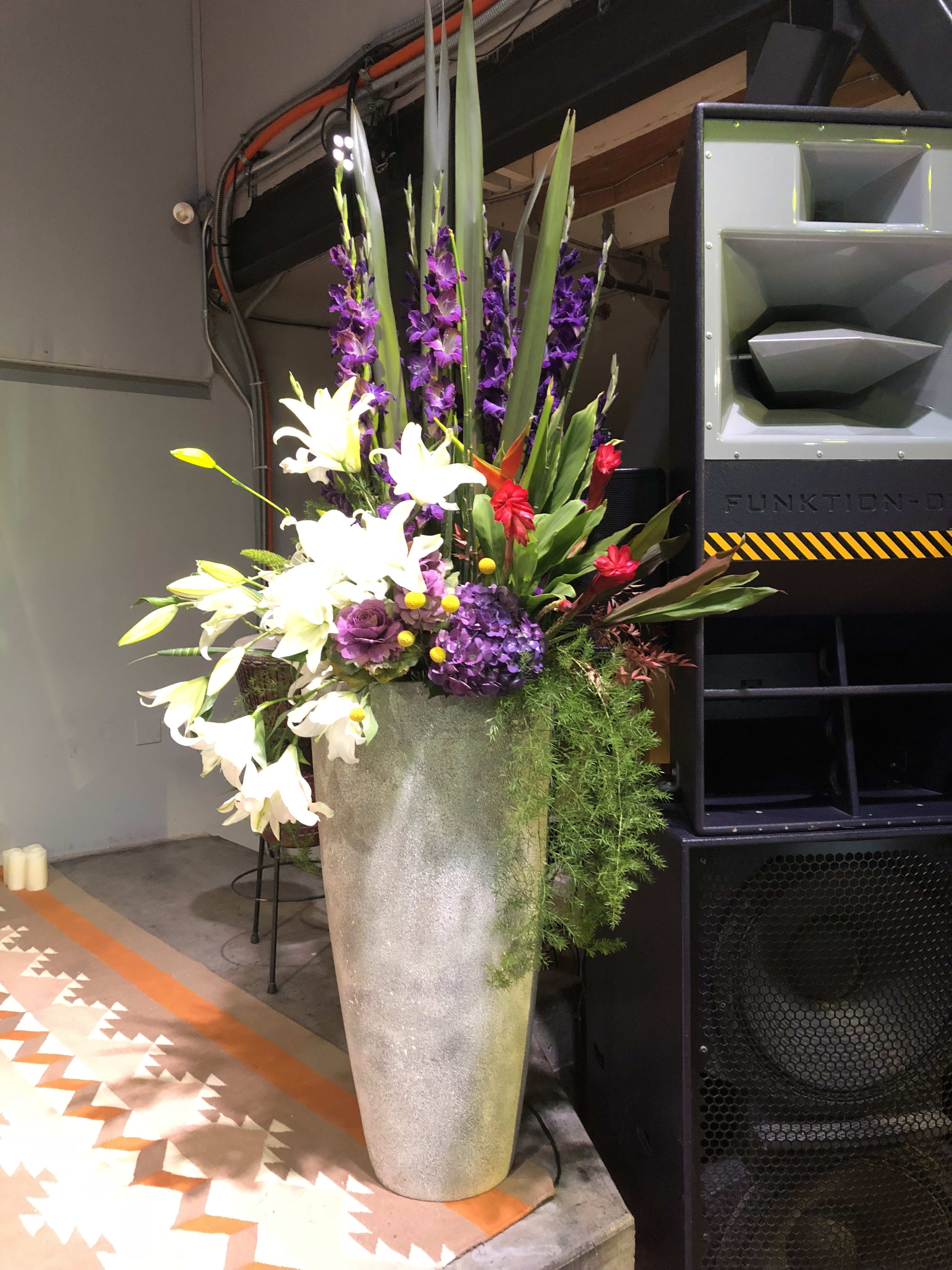 Grand Farewell Tribute - A Memorial Tribute that will hold the stage when the stage is empty. This showy display for a highly honored community leader utilizes our large rental pedestal urn with flowers specific to the Honored Individual. Consultation required and special delivery fee. 