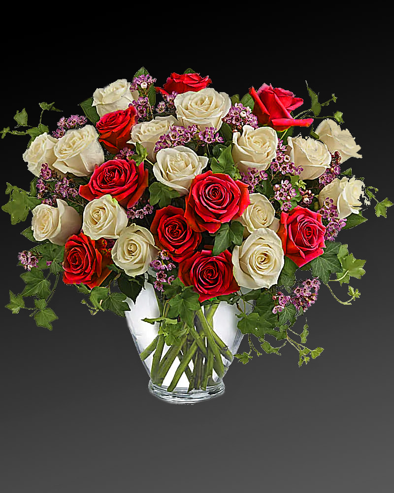Victorian Romance Flowers - Send an English garden someone's way with this gorgeous arrangement. Tendrils of green ivy trail delicately from a beautiful bunch of cream-colored and lavender roses with lavender waxflower for a bouquet that's both traditional and unexpected. Fifteen crème roses and nine lavender roses, lavender waxflower and ivy are perfectly arranged in a serenity glass vase. Orientation: All-Around