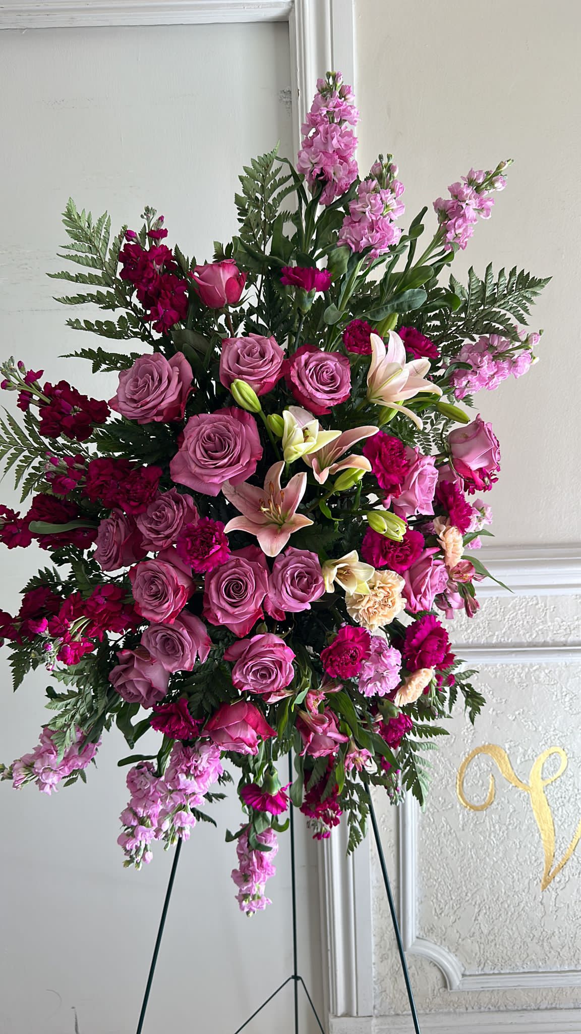 Purple Standing Spray Purple Standing Spray - A beautiful purple standing spray with flowers such a purple and pink stock, purple roses, pink lilies and greenery. Perfectly for saying goodbye to a loved one.