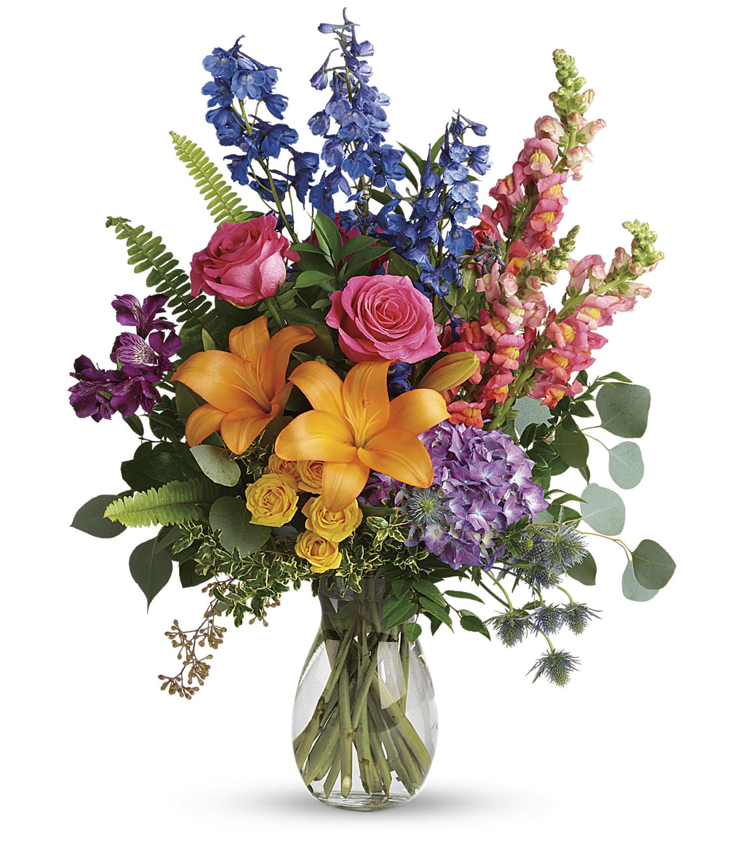 Colors of the Rainbow - Color any occasion beautiful with this lovely bouquet of hydrangea, roses and lilies in all the colors of the rainbow.  his colorful bouquet includes purple hydrangea, pink roses, yellow spray roses, orange asiatic lilies, purple alstroemeria, blue delphinium, pink snapdragons, blue eryngium, huckleberry, oregonia, Israeli ruscus, sword fern, silver dollar eucalyptus, seeded eucalyptus, and lemon leaf. Delivered in a jordan vase. Approximately 22&quot; W x 28 1/2&quot; H