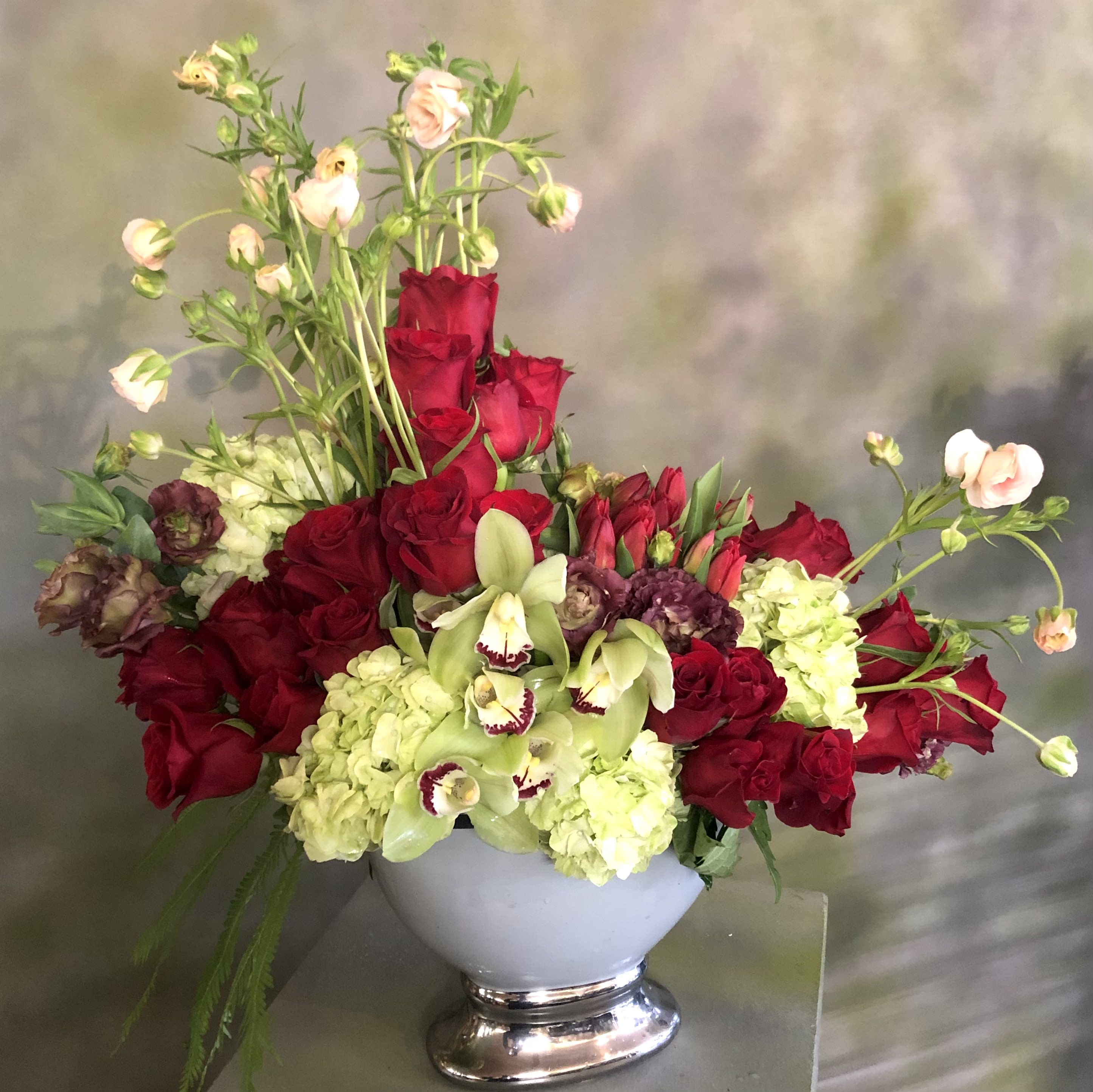 Art Nouveau #EF233 - A beautiful Floral Arrangement in an oval ceramic vase with Butterfly Flowers  ( Seasonal) over 24 red Roses, Red Tulips, Green Hydrangea &amp; orchid