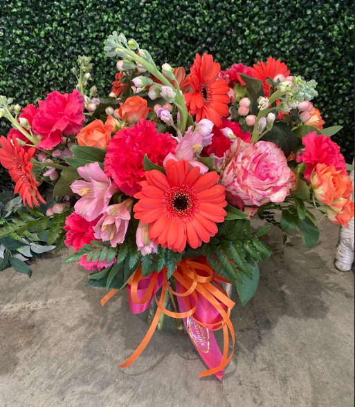 Orange Red Glow - Gerbera daisies with roses and lisianthus.