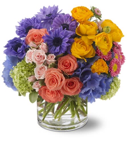 Spring Sonnet - Add a bit of poetry to someone's day with this spectacular bouquet featuring pink roses gathered with whimsical purple anemone, sunny yellow ranunculus and more. It's a perfect spring sonnet of color!   Pink roses and Matsumoto asters, light pink spray roses, purple anemone, blue hydrangea, yellow ranunculus and green viburnum are delivered in a glass cylinder vase. Approximately 13&quot; (W) x 12&quot; (H) 