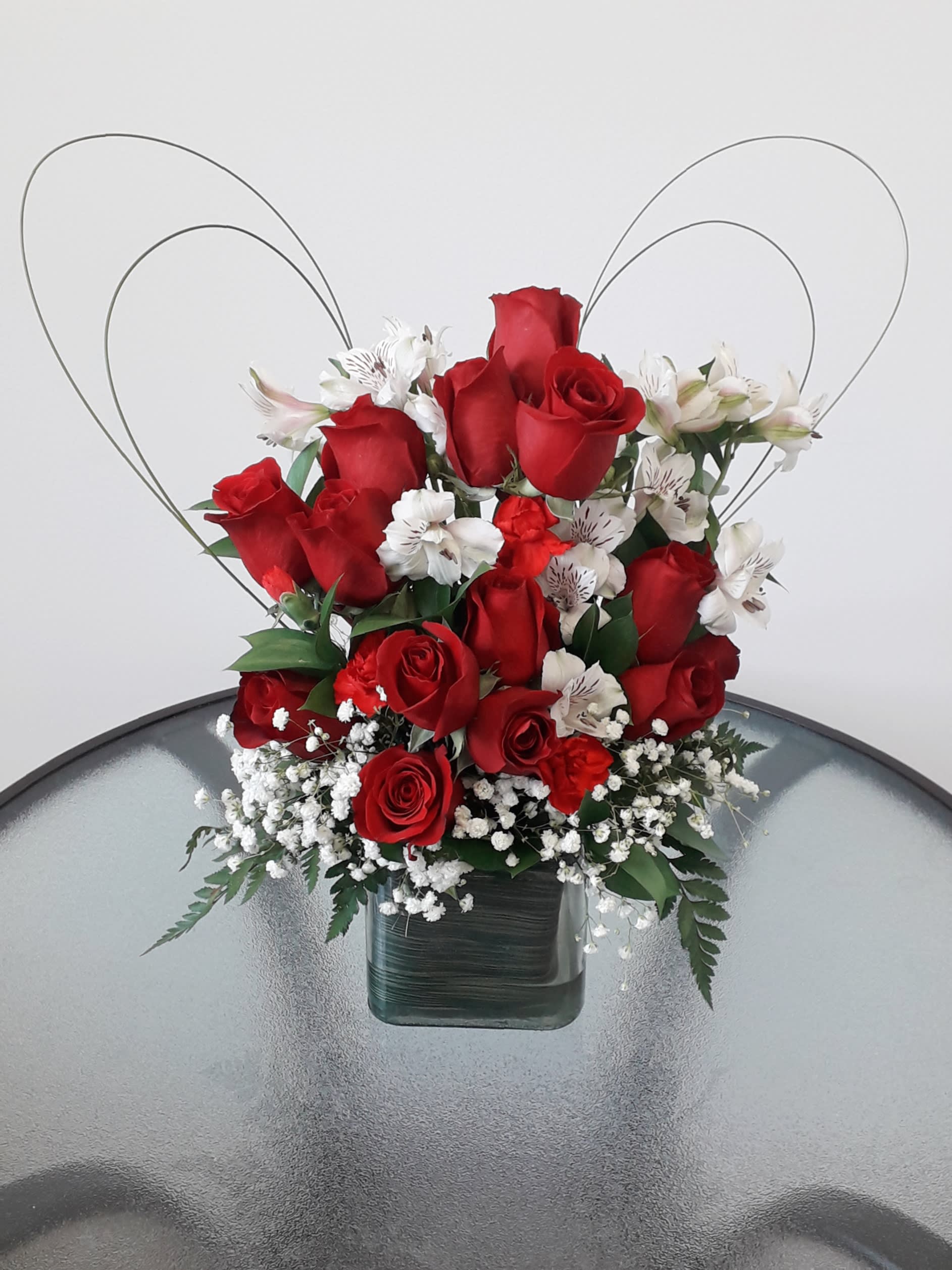 ROSES IN YOUR HEART ROSES IN YOUR HEART - A PERFECT COMBINATION OF 12 RED ROSES IN A CUBE VASE WITH A HEART SHAPE AND A PERFECT TOUCH OF BABIES BREATH Flowers and similar colors