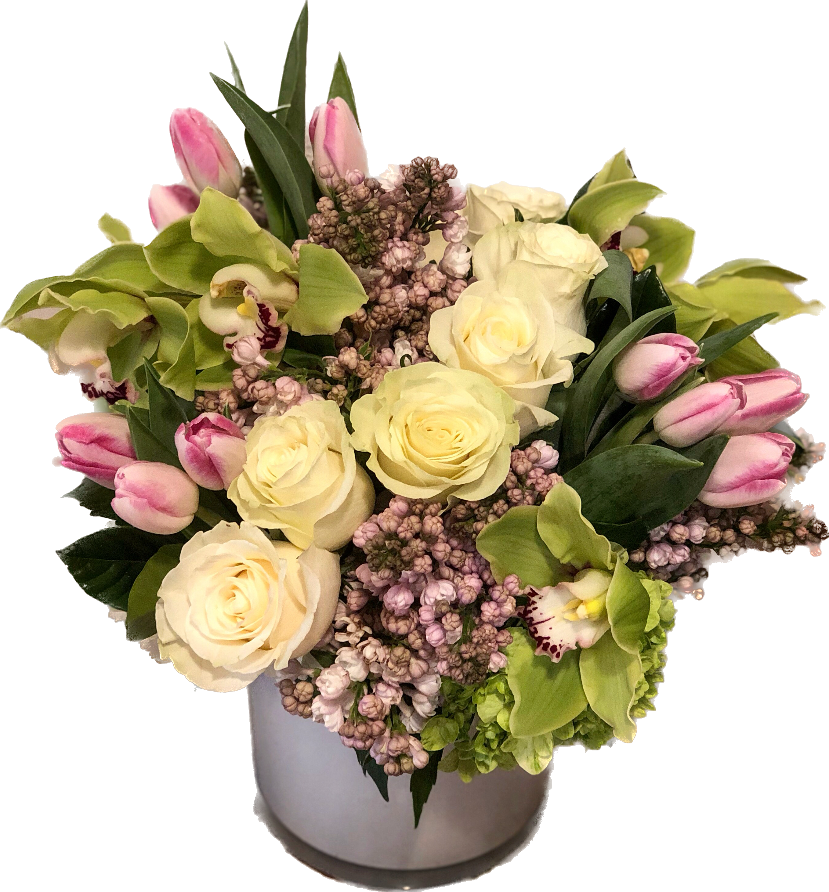 Spring Perfection - A beautiful arrangement of roses, tulips due to availability, hydrangea, lilac and cymbidium orchids.  Designed in a short, chic white cylinder.  