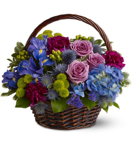 Twilight garden Basket - To capture the gentle moment of twilight - when flowers in the garden seem to take on a mystical quality - send this mix of fresh blooms in shades of blue, green and lavender, presented in a woven basket. A wonderful gift for birthdays or any special occasion.   A mix of fresh flowers such as roses, hydrangea, irises and button spray chrysanthemums â in shades of blue, green, lavender and fuchsia â is accented with greenery and presented in a woven handled basket. Approximately 15&quot; (W) x 14&quot; (H) 