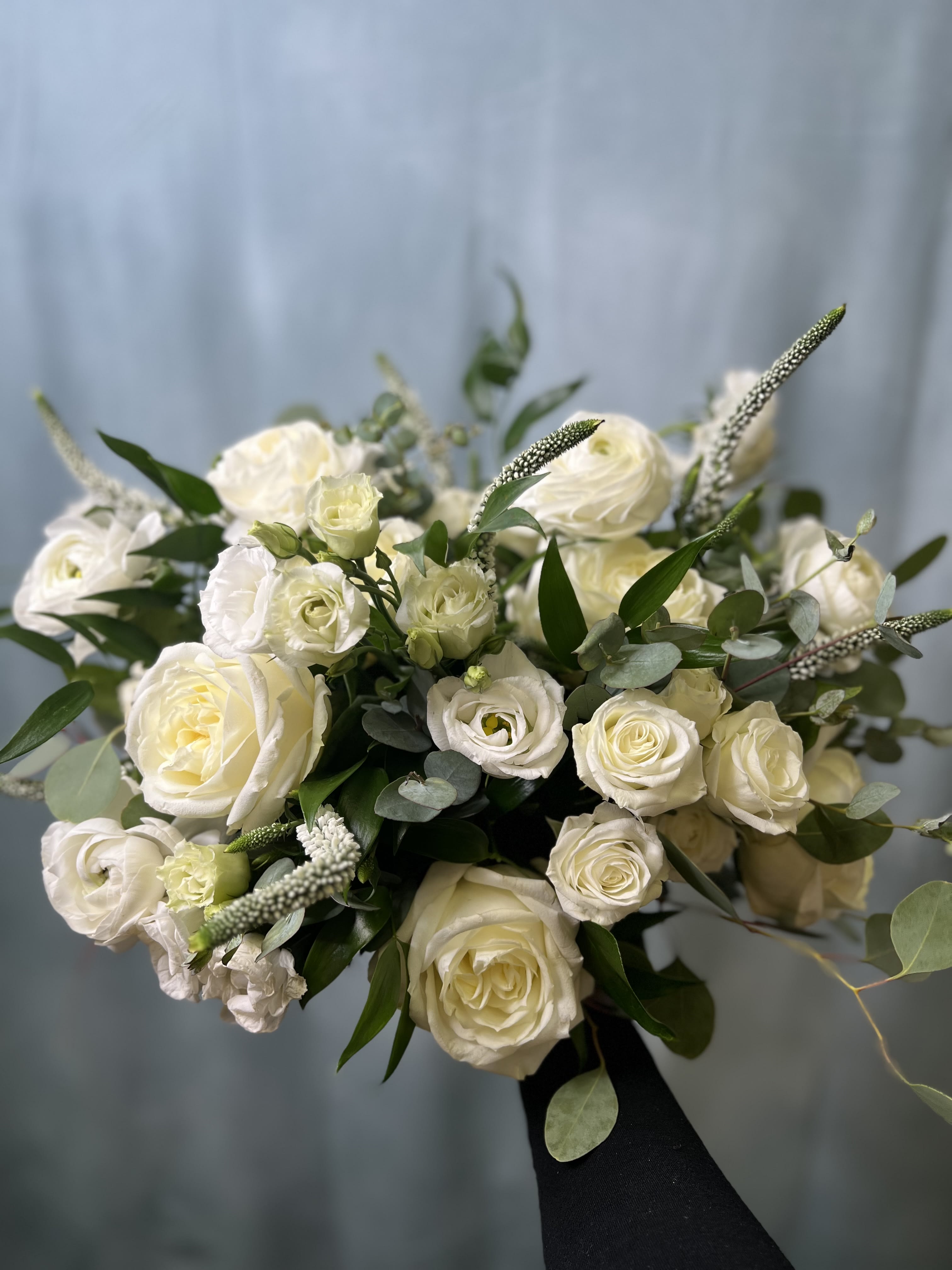 Classic White Bridal Bouquet Classic White Bridal Bouquet - White roses, ranunculus, lisianthus, and other blooms and greens.